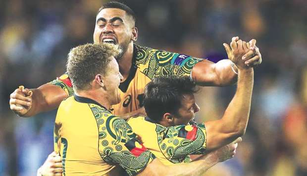 (From L to R) Reece Hodge, Lukhan Tui and Nick Phipps of Australiau2019s Wallabies celebrate their victory over New Zealand at Suncorp Stadium in Brisbane yesterday.