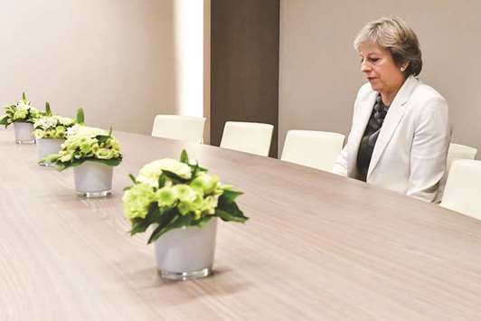 This picture taken on Friday shows May sitting alone after arriving for a meeting with European Council President Donald Tusk in Brussels. A version of the picture appeared in this paper yesterday.