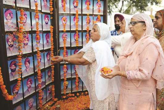 Relatives of slain Punjab police personnel attend an event to mark Police Commemoration Day at a police station on the outskirts of Amritsar yesterday.
