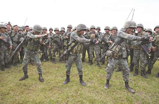 Members of the Philippine Marine Batallion Landing Team (MBLT) perform the u201cBaby Sharku201d dance to entertain their comrades during their send-off ceremony ending their combat duty against pro-Islamic State groups inside a military headquarters in Marawi city, southern Philippines yesterday.