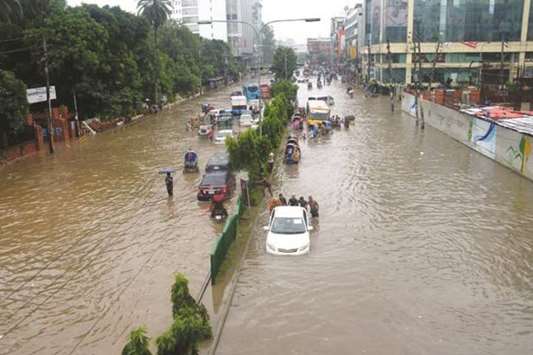 Vehicles submerged on a waterlogged road in Dhaka yesterday. Most of the roads, lanes and bylanes in the capital city suffer from serious waterlogging due to incessant rainfall since Thursday night.