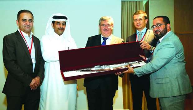 Ozer presents a token of recognition to Daien Group chairman Sheikh Khalifa bin Nasser al-Thani on the sidelines of a B2B meeting between Qatari and Turkish companies held yesterday. Looking on are Deveci and other dignitaries. PICTURE: Jayaram