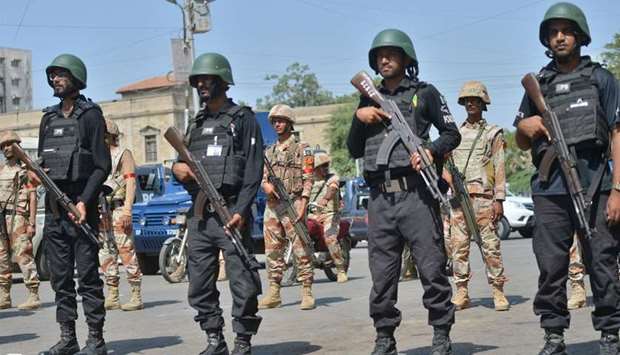 Pakistani security personnel stand guard in Karachi