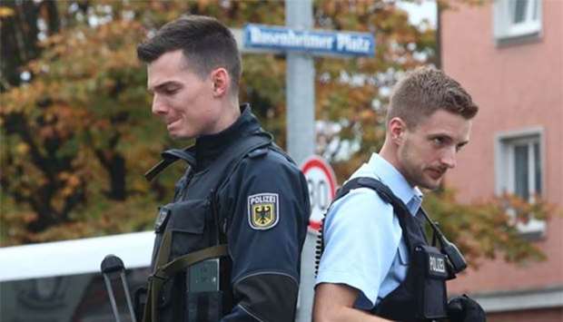 German police officers guard the site where a man injured several people in a knife attack in Munich.