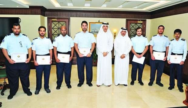 Seven of the inspectors who were honoured are seen with officials.