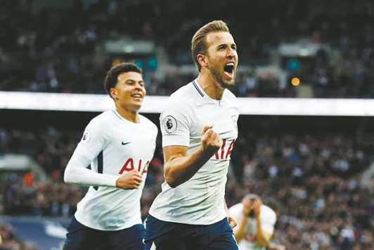 Tottenham Hotspuru2019s English striker Harry Kane celebrates after scoring their fourth goal against Liverpool at Wembley Stadium in London yesterday.