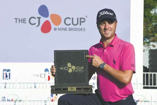 Justin Thomas of the US poses with the trophy after winning the CJ Cup at Nine Bridges in Jeju Island, South Korea, yesterday. (AFP)