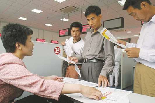 Unemployed men look for jobs at a labour market in Shenyang. Chinau2019s unemployment rate has hit its lowest point in multiple years at 3.95% by the end of September, but employment is still facing challenges as the economy pushes ahead with structural reforms, Chinau2019s labour ministry said yesterday.