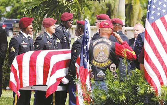 A honour guard carries the coffin of US Army Sergeant La David Johnson, who was among four special forces soldiers killed in Niger, at a graveside service in Hollywood, Florida.