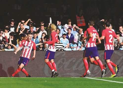 Atletico Madridu2019s French forward Kevin Gameiro (L) celebrates with teammates after scoring against Celta de Vigo in Vigo yesterday.