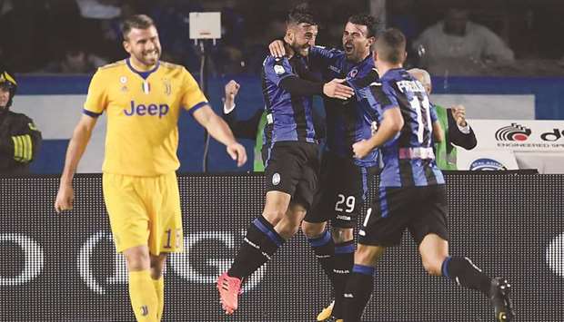Atalantau2019s Bryan Cristante (second left) celebrates with teammates after scoring against Juventus in Serie A on Sunday. (AFP)