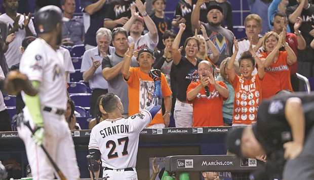Miami Marlinsu2019 Giancarlo Stanton (centre, also inset) gets a standing ovation from fans after striking out at the bottom of the ninth inning during the game against Atlanta Braves in Miami, Florida, on Sunday. (Miami Herald/TNS)