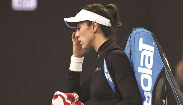 Garbine Muguruza of Spain walks off the court after retiring from her singles match against Barbora Strycova of the Czech Republic at the China Open in Beijing yesterday. (AFP)