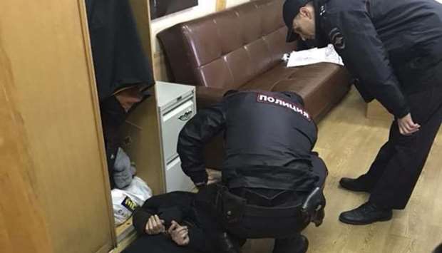 Policemen detain an intruder, who attacked Tatyana Felgengauer, anchor of Russian radio station Ekho Moskvy in Moscow