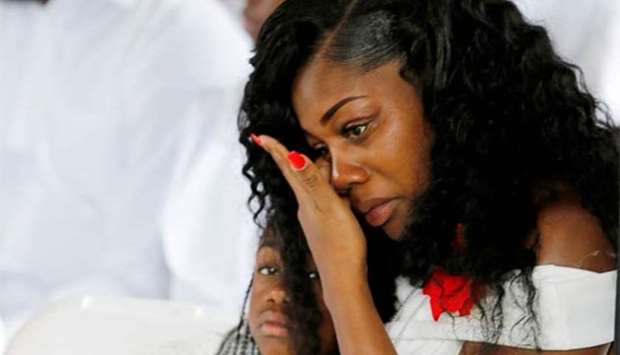 Myeshia Johnson, widow of US Army Sergeant La David Johnson, who was among four special forces soldiers killed in Niger, sits with her daughter, Ah'Leeysa Johnson at a graveside service in Hollywood, Florida, on Saturday.