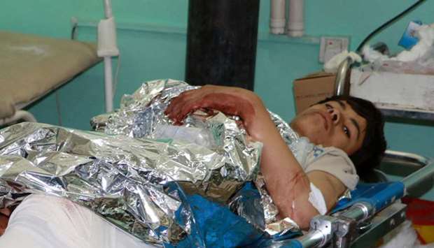 A boy injured in a Saudi-led air strike lies in a hospital bed in Saada, Yemen