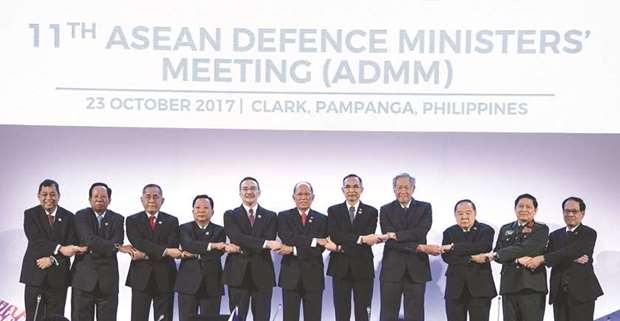The Association of Southeast Asian Nations (Asean) Defence Ministers (from left): Bruneiu2019s Minister of Energy and Industry Haji Mohamed Yasmin bin Haji Umar, Cambodiau2019s Defence Minister and Deputy Prime Minister Samdech Pichey Sena Tea Banh, Indonesiau2019s Defence Minister Ryamizard Ryacudu, Lao PDRu2019s Defence Minister Chansamone Chanyalath, Malaysiau2019s Defence Minister Datou2019 Seri Hishammuddin bin Tun Hussein, Philippinesu2019 Defence Secretary and Chairman of the Asean Defence Ministersu2019 Meeting Delfin Lorenzana, Myanmaru2019s Defence Minister Sein Win, Singaporeu2019s Defence Minister Ng Eng Hen, Thailandu2019s Defence Minister and Deputy Prime Minister Prawit Wongsuwan, Vietnamu2019s Defence Minister Ngo Xuan Lich and Asean Secretary General Le Luong Minh link arms during the 11th Asean Defence Ministersu2019 Meeting (ADMM) opening ceremony in Clark, east of Manila yesterday.