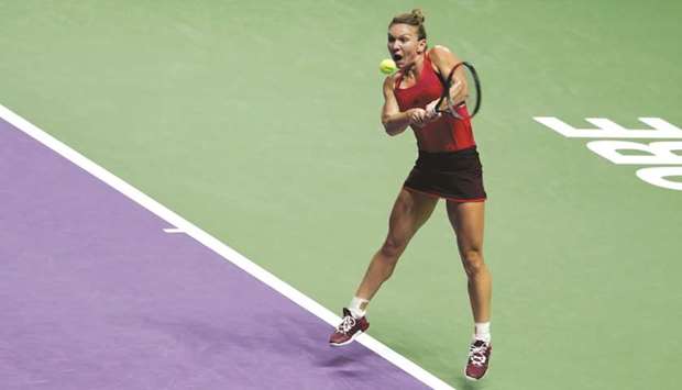 Romaniau2019s Simona Halep whips a backhand during her win over Franceu2019s Caroline Garcia at the WTA Tour Finals in Singapore yesterday. (Reuters)
