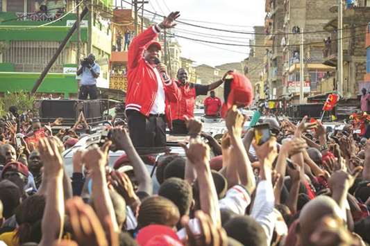 Supporters greet Kenyau2019s President Uhuru Kenyatta (front centre) and Deputy-President William Ruto (rear right) during a political rally in Nairobi yesterday.