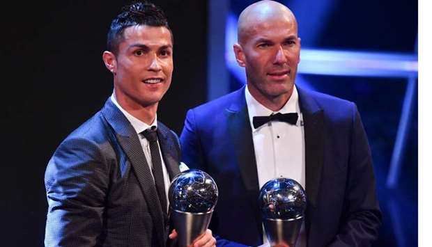 Real Madrid and Portugal forward Cristiano Ronaldo (left) poses with Real Madrid's French coach Zinedine Zidane after winning the player and coach of the year award respectively at The Best FIFA Football Awards ceremony in London on Monday