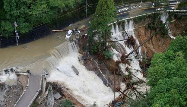 A collapsed road is seen following torrential rain caused by typhoon Lan in Kishiwada