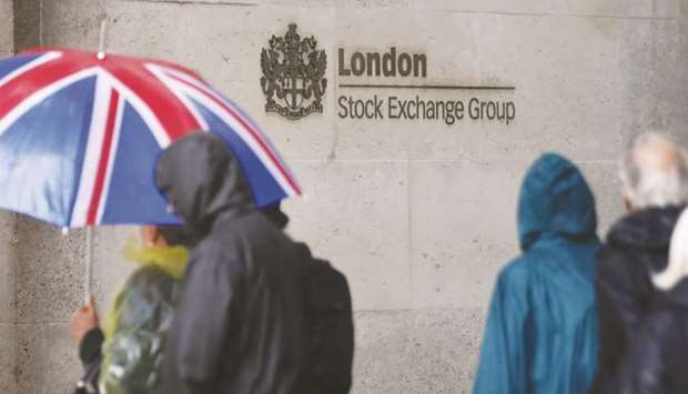Pedestrians walk past the London Stock Exchange. The FTSE 100 rose 0.02% to 7,524.45 yesterday.