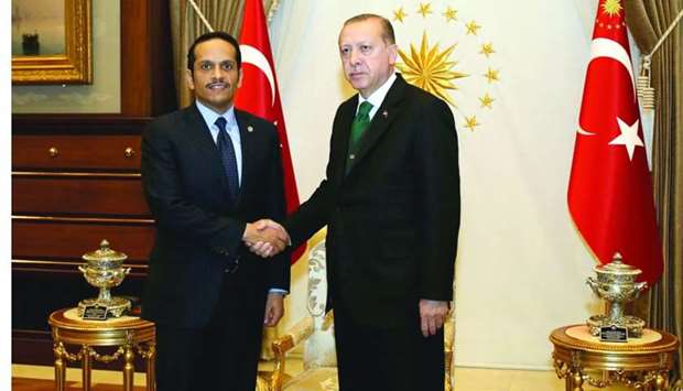 Turkish President Recep Tayyip Erdogan shake hands with HE the Foreign Minister of Qatar Sheikh Mohamed bin Abdulrahman al-Thani 