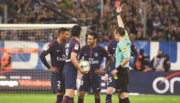 French referee Ruddy Buquet (right) shows a red card to Paris Saint-Germainu2019s Neymar (centre) during the Ligue 1 match against Marseille at the Velodrome Stadium in Marseille, France, on Sunday. (AFP)
