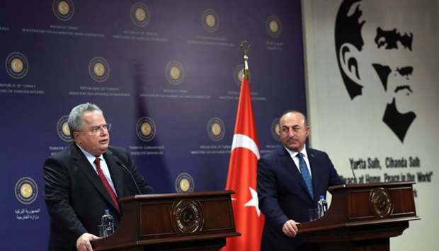 Turkish Foreign Minister Mevlut Cavusoglu (R) and Greek Foreign Minister Nikos Kotzias (L) hold a joint press conference after their meeting in Ankara. AFP
