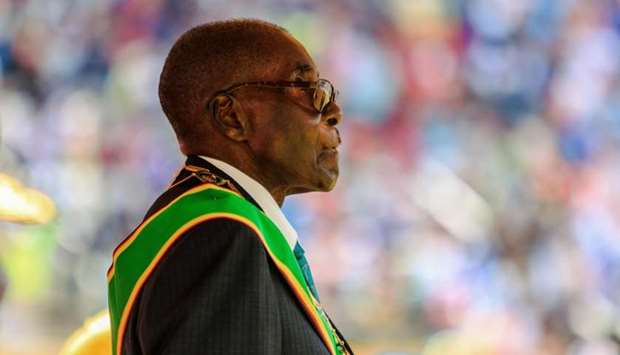 Robert Mugabe reviewing the guard of honour during the country's 37th Independence Day celebrations at the National Sports Stadium in Harare. File photo taken on April 18, 2017