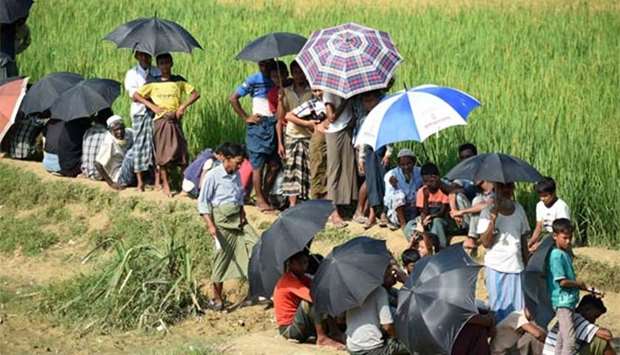 Rohingya refugees wait for relief aid at Balukhali refugee camp in the Bangladeshi district of Ukhia on Tuesday.