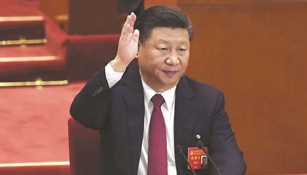 Chinese President Xi Jinping raises his hand to vote for the reports with other Chinau2019s leaders at the closing of the 19th Communist Party Congress at the Great Hall of the People in Beijing yesterday. Chinese President Xi Jinpingu2019s name was added to the Communist Partyu2019s constitution at a defining congress, elevating him alongside Chairman Mao to the pantheon of the countryu2019s founding giants.