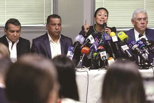 Laidy Gomez, elected governor of Tachira state, talks to the media during a news conference, next to elected governor of Merida state Ramon Guevara (left), elected governor of Nueva Esparta state Alfredo Diaz (second left) and elected governor of Anzoategui state Antonio Barreto, in Caracas, Venezuela, yesterday.