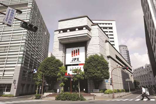 The Tokyo Stock Exchange building (centre) in Tokyo. The Nikkei 225 closed yesterday at its highest since 1996, buoyed by Prime Minister Shinzo Abeu2019s landslide election win.