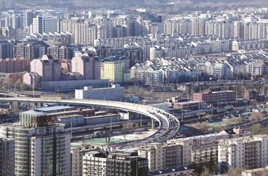 Residential buildings are seen in Beijing. Chinau2019s property investment and construction are seen slowing as more cities try to curb surging housing prices, while a government campaign against riskier lending pushes up borrowing costs and a crackdown on pollution hurts some factories.