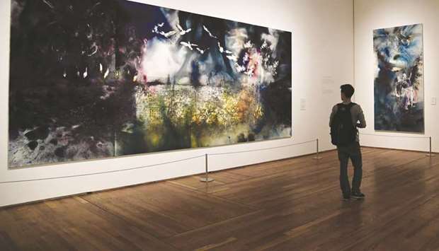 A man looks at Day and Night in Toledo by Chinese artist Cai Guoqiang during the presentation of his exhibition The Spirit of Painting at El Prado museum in Madrid.