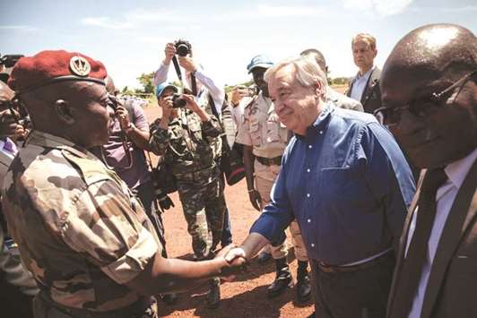 United Nations Secretary-General Antonio Guterres shakes hands with a UN officer on the tarmac of the Bangassou airport.