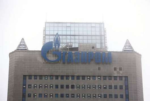 A logo is displayed above the headquarters of Gazprom in Moscow. Gazprom, Transneft and Sberbank are among companies that will pay less in dividends than anticipated this year and next as they are able to discuss the size of payouts directly with President Vladimir Putin, according to officials.