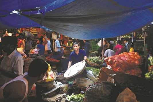 Vendors work at a vegetable market in Mumbai. The latest Reuters poll predicted Indiau2019s retail inflation to average 3.5% this fiscal year, unchanged from the July median but below the central banku2019s medium-term target of 4%.