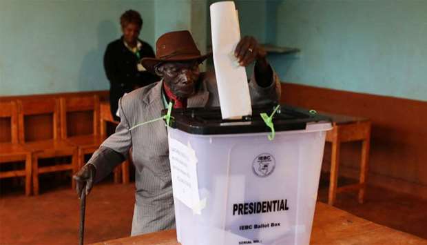 A man casts his vote inside a polling station during a presidential election re-run in Gatundu