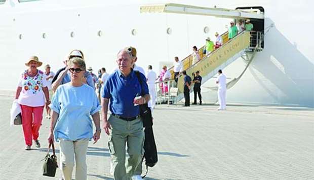 Cruise passengers disembark from Seabourn Encore at the Doha Port.