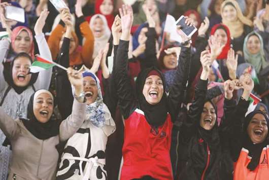 Female Palestinian students cheer as they watch a local volleyball competition in Khan Younis, Gaza Strip, yesterday.
