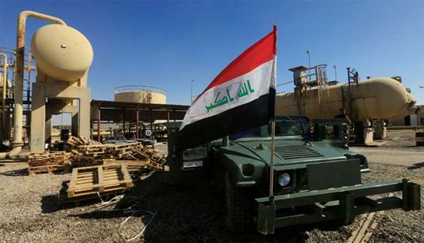 An Iraqi flag is seen on a military vehicle at an oil field in Dibis area