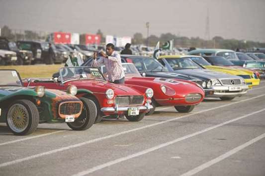 A Pakistani man takes pictures of vintage cars at the end of Motor Rally in Islamabad recently. The rally which is organised by Pakistanu2019s army gathered different vehicles from 23 different motor clubs across Pakistan.
