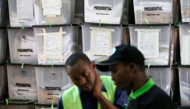 Independent Electoral and Boundaries Commission (IEBC) officials talk near stacked ballot boxes at a tally centre in Nairobi, Kenya. Reuters