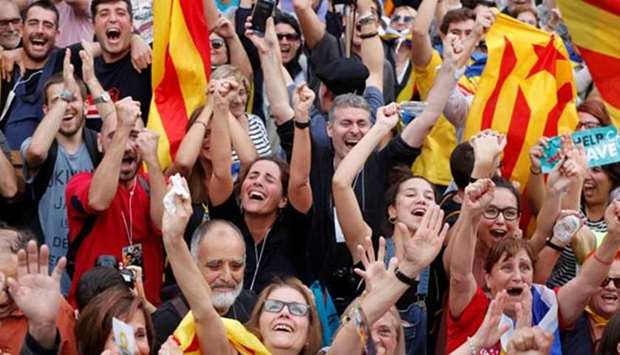 People celebrate after the Catalan regional parliament passed the vote of independence from Spain in Barcelona on Friday.