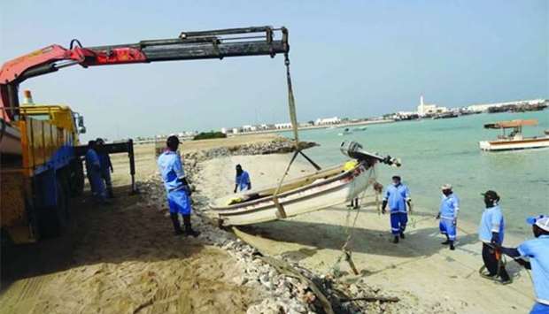 An abandoned boat being removed from Al Ruwais Port.