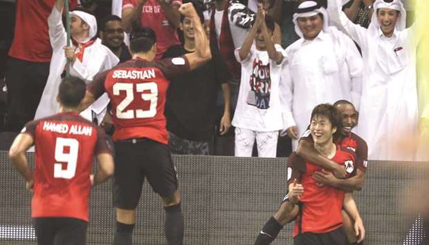 Koh Myong-Jin (R) is congratulated after he scored the winner for Al Rayyan.