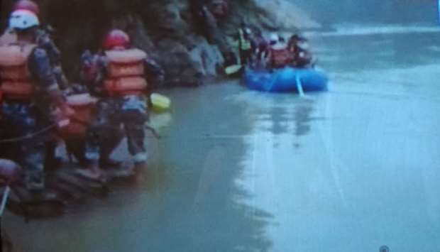 Security personnel searching for missing passengers of the bus that plunged into Trishuli River. Picture courtesy: Avenues TV image/Sureis/Himalayan Times