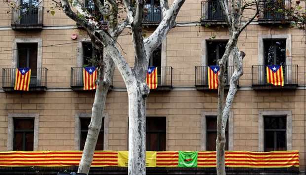 Catalan flags hang from balconies the morning after the Catalan regional parliament declared independence from Spain in Barcelona, Spain. Reuters